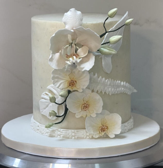 Elegant White Orchid Cake Elegant white custom cake decorated with handcrafted white orchids and delicate floral details