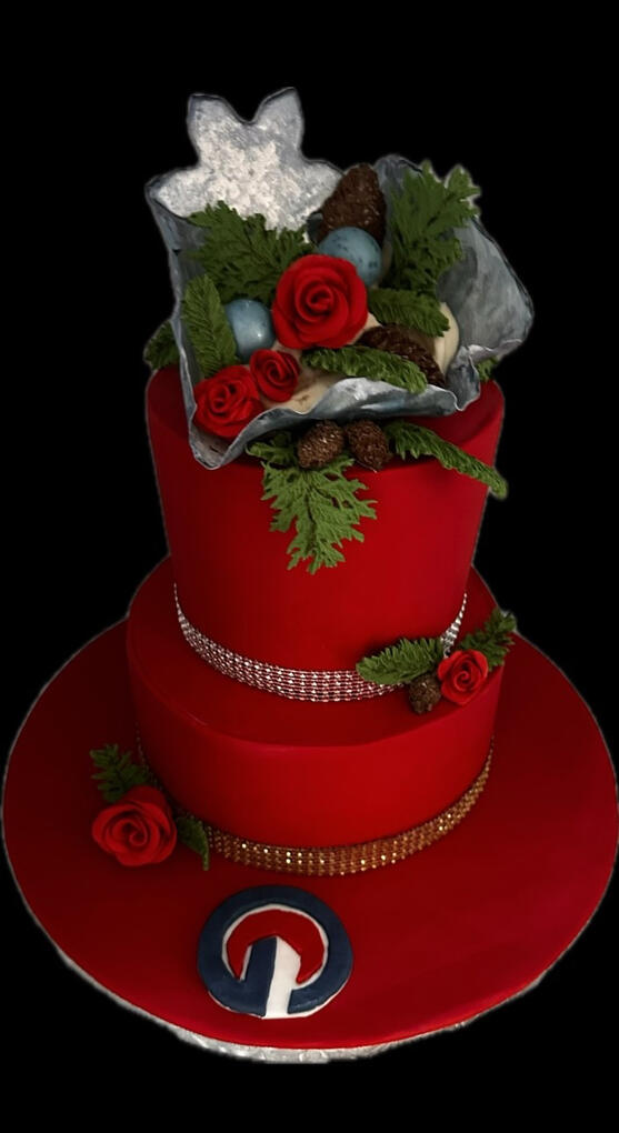 Corporate Christmas Cake Red corporate Christmas cake decorated with handcrafted roses, greenery, and elegant holiday details.